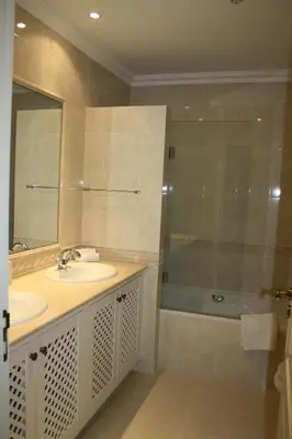 a bathroom with a sink and a shower and a mirror at Quinta Formosa - Villas in Quinta do Lago