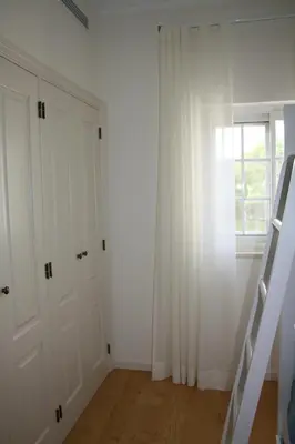 a white room with white doors and a window at Quinta Formosa - Villas in Quinta do Lago