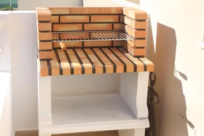 a shelf made out of wood and bricks at Albufeira Lovely new Apartment W/ Pool in Albufeira