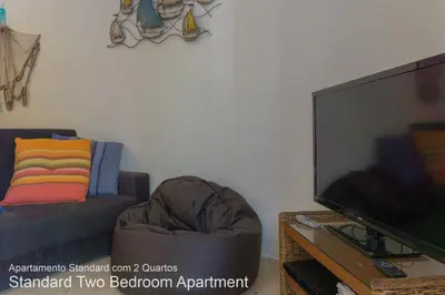 a living room with a couch and a television at Akisol Vilamoura Nature in Vilamoura