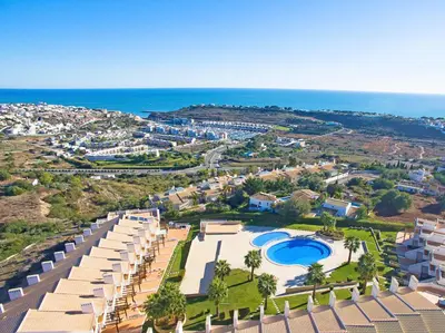 an aerial view of a resort with a pool and the ocean at Townhouse Mar 1 by Algarve Vacation in Albufeira