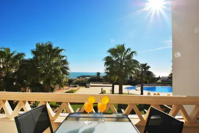 a table on a balcony with a view of a pool at Townhouse Mar 1 by Algarve Vacation in Albufeira