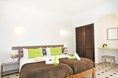 a bedroom with two beds with green pillows at Apartment Capri by Algarve Vacation in Albufeira