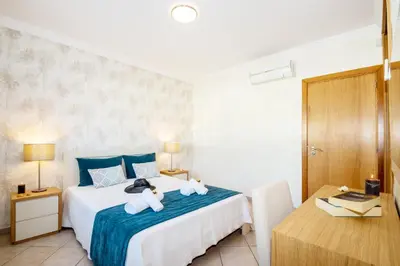 a bedroom with a bed with two stuffed animals on it at Villa Alegria by Algarve Vacation in Albufeira