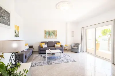 a living room with a couch and a table at Villa Valentina by Algarve Vacation in Almancil