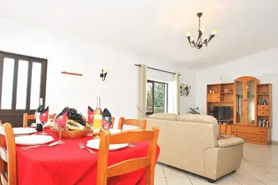 a living room with a table with a red table cloth at Villa Martinica by Algarve Vacation in Guia