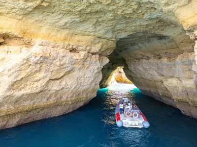 a boat in a cave in the water at Villa Belize by Algarve Vacation in Albufeira