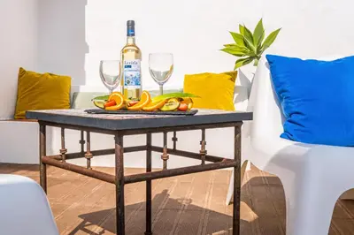 a table with a bottle of wine and two glasses at Villa Belize by Algarve Vacation in Albufeira