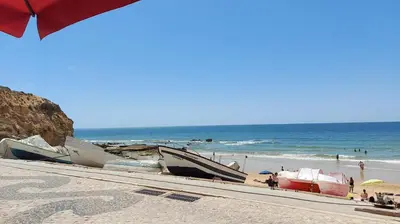 a group of boats on a beach near the ocean at Olhos do Mar in Albufeira