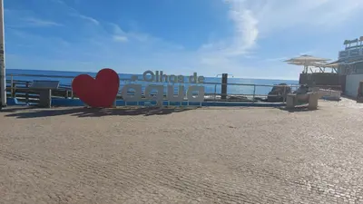a sign on the beach with a red heart at Olhos do Mar in Albufeira