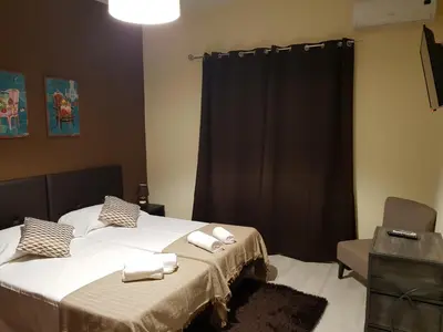 a bedroom with two beds with white towels on them at Almancil Hostel in Almancil