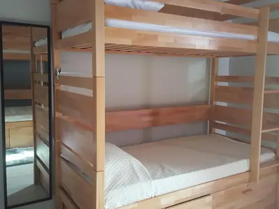 a bunk bed room with wooden bunk beds at Almancil Hostel in Almancil