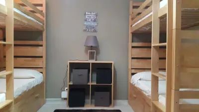 a room with two bunk beds and a lamp at Almancil Hostel in Almancil
