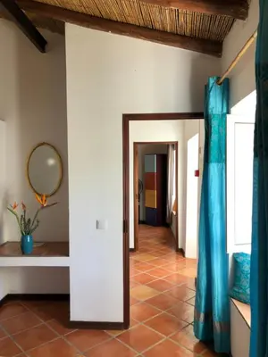 a hallway with a tile floor and a mirror at Quinta Quinze in Boliqueime