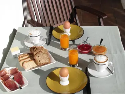 a table with eggs and bread and cups of coffee at Quinta Quinze in Boliqueime