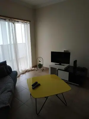 a living room with a couch and a yellow coffee table at Edifice Ibérico in Albufeira