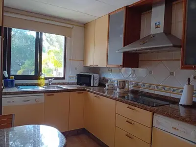 a kitchen with a sink and a microwave at Apartamento Falesia 6 B in Albufeira
