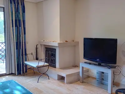 a living room with a tv and a fireplace at Apartamento Falesia 6 B in Albufeira