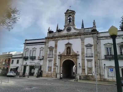 an old building with a clock tower on top of it at Rooms_Heart Apartment in Faro