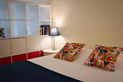 a bedroom with a bed with two pillows and a lamp at Old Village Prestige 101 in Vilamoura