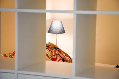 a room with a table with a lamp and a chair at Old Village Prestige 101 in Vilamoura