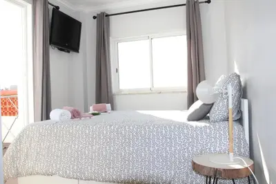a bedroom with a bed and a window at Beach Center 2 - 300m beach in Albufeira