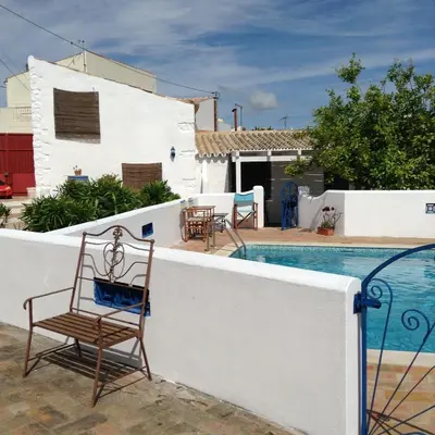 a chair sitting on the side of a swimming pool at Casa da Esperança – Rural and beach Villa in Algarve in Boliqueime