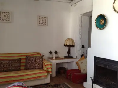 a living room with a couch and a table at Casa da Esperança – Rural and beach Villa in Algarve in Boliqueime