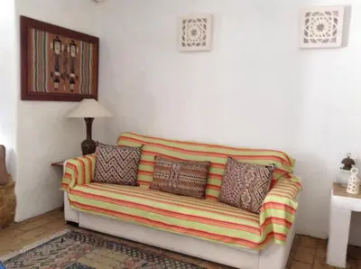 a living room with a couch with pillows on it at Casa da Esperança – Rural and beach Villa in Algarve in Boliqueime