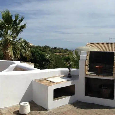 a white building with an outdoor oven on a roof at Casa da Esperança – Rural and beach Villa in Algarve in Boliqueime
