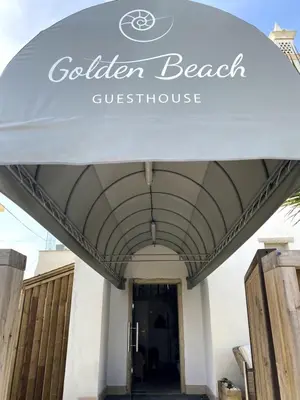 a hotel room with two beds with towels on them at Golden Beach Guest House & Rooftop Bar in Faro
