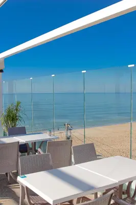 a bathroom with two sinks and a bath tub at Golden Beach Guest House & Rooftop Bar in Faro