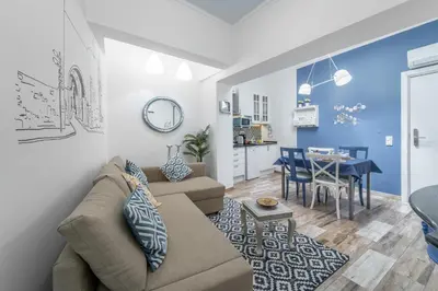 a living room and kitchen with a couch and a table at Main Street Apartments by Raspberry Cascade in Faro