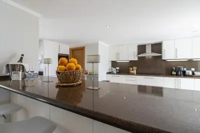 a kitchen and dining room with a table and chairs at Villa Vista in Valados