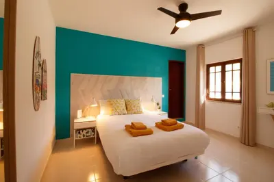 a bedroom with a bed with two towels on it at Quinta do Paraíso - Bed&Shower in Albufeira