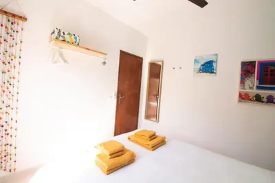 a bedroom with two towels on a bed at Quinta do Paraíso - Bed&Shower in Albufeira