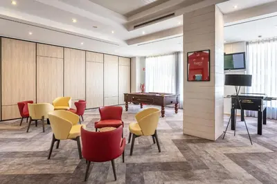 a dining room with tables and chairs and windows at AP Victoria Sports & Beach in Albufeira