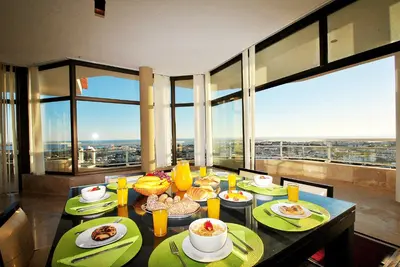 a dining room with a table with plates of breakfast food at Penthouse Miami by Algarve Vacation in Albufeira