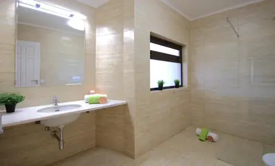 a bathroom with a sink and a mirror and a shower at Penthouse Miami by Algarve Vacation in Albufeira