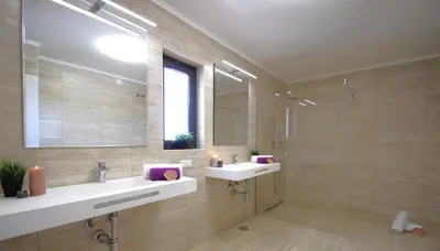 a bathroom with two sinks and a large mirror at Penthouse Miami by Algarve Vacation in Albufeira