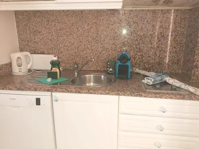 a kitchen counter top with a sink and a counter top at Pé na Praia in Albufeira