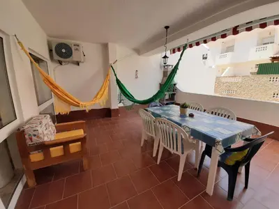 a dining room with a blue table and chairs at Beach Falésia Alfamar in Albufeira