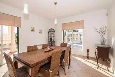 a large kitchen with wooden cabinets and stainless steel appliances at Quinta das Yuccas in Boliqueime