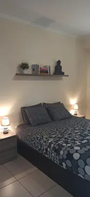 a bedroom with a bed with two lamps on it at Casa Sensa in Albufeira