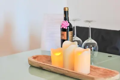 a bottle of wine and a bunch of candles on a table at L14 by MTPhomes in Vale de Pedras