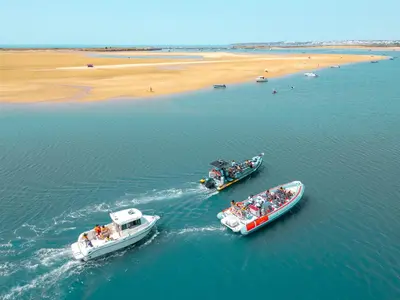 two boats in the water next to a beach at Villa Mauritius by Algarve Vacation in Albufeira