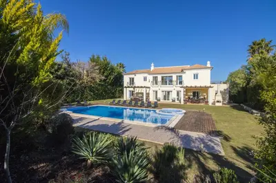 a villa with a swimming pool and a house at Villa Mar in Almancil
