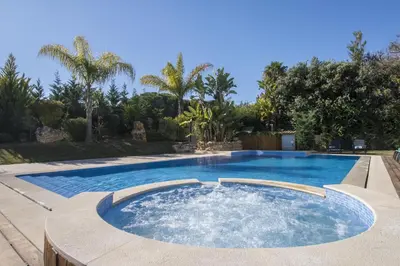 a swimming pool in a backyard at night at Villa Mar in Almancil
