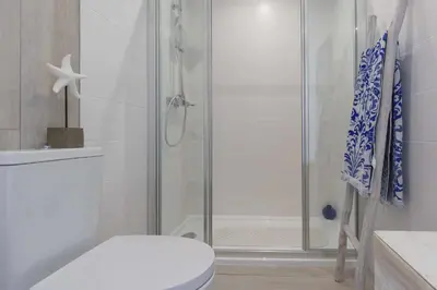 a bathroom with a shower with a toilet and a sink at Boat View - Marina Plaza - By VilamouraSun in Vilamoura