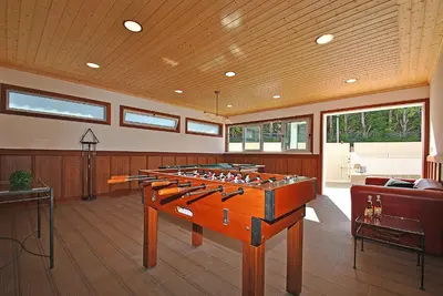 a living room with a foosball table in the middle at Villa Buddha by Algarve Vacation in Albufeira
